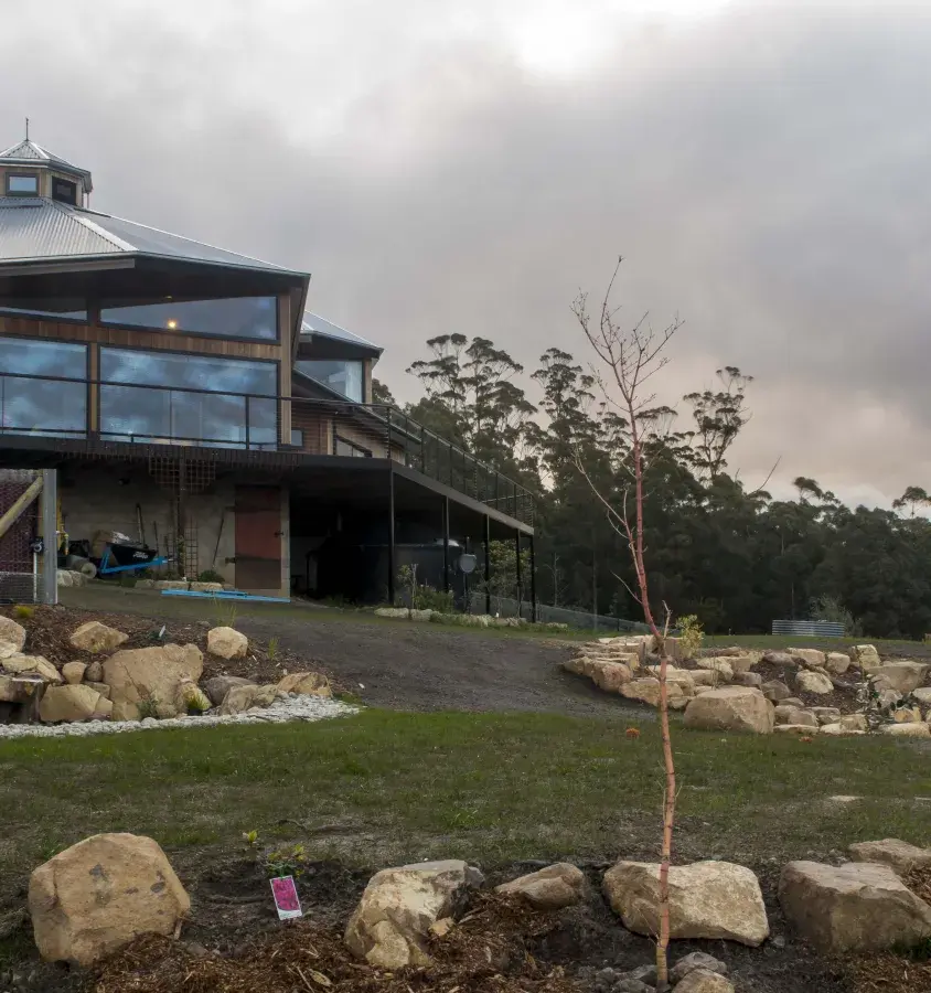 House on acreage with extensive north facing windows and landscaped gardens in Oyster Code 